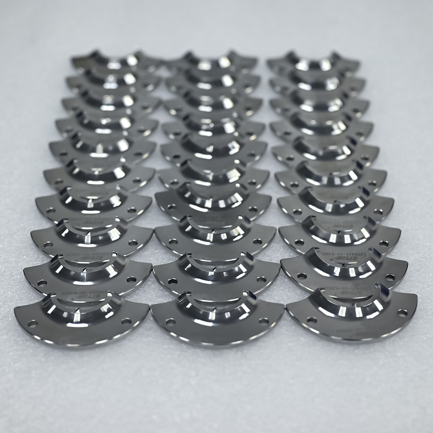 A compelling comparison image placing a new BaiJinYi rotate stopper next of a heavily worn competitor part. This visual directly communicates the key value proposition: our product's superior material (FS139M steel) and vacuum quenching process result in a dramatically extended operational lifespan, reducing changeover frequency and cost.